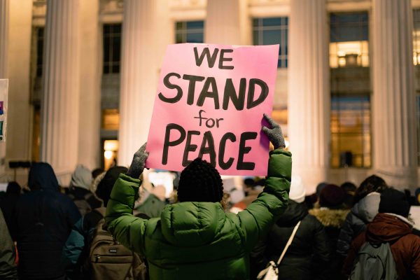 Community members gather in front of U-M’s Angell Hall on Jan. 3 to protest U.S. involvement in the Middle East after the recent U.S. drone strike on Iraq. Torrence Williams | Washtenaw Voice