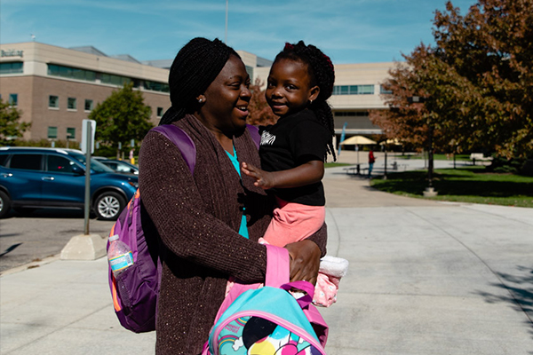 Student parent with their child. Torrence Williams | Washtenaw Community College
