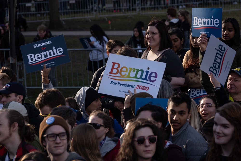 Supporters gather with signs to hear presidential candidate Bernie Sanders speak at March 8 rally. Torrence Williams | Washtenaw Voice