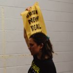 Protester from the Sunrise Movement demanding support of the Green New Deal is Iescorted out of Joe Biden's rally by police.