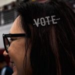 Karla Waterhouse of Rochester Hills wears a "VOTE" hair clip at presidential candidate Joe Biden's Monday night rally in Detroit.