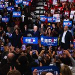 From left, Sen. Kamala Harris, presidential candidate and former Vice President Joe Biden, Michigan Gov. Whitmer and Sen. Cory Booker stand hand-in-hand at Biden's Monday rally in Detroit.