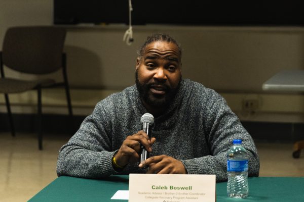 Caleb Boswell, a student adviser, speaks as one of the panelists at the Strength Over Silence event.