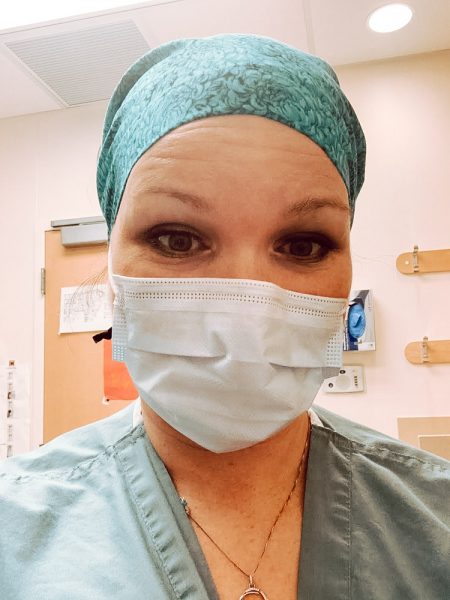Nurse Jamie Langlois takes a selfie wearing her medical mask and scrubs. 