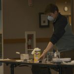 A volunteer setting up a temperature taking station. Torrence Williams | Washtenaw Voice
