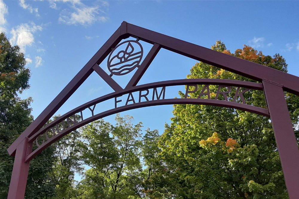 The sign at the entrance of Ann Arbor’s County Farm Park. With 81 mixed annual/perennial plots at the park, it is Project Grow’s largest site. Debra Destefani | Washtenaw Voice