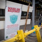 Sign on a blockade in Downtown Ann Arbor informing pedestrians about COVID-19 restrictions. Torrence Williams | Washtenaw Voice