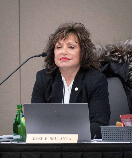WCC's President Bellanca is shown from the shoulders up, sitting at a desk behind an open laptop and microphone.