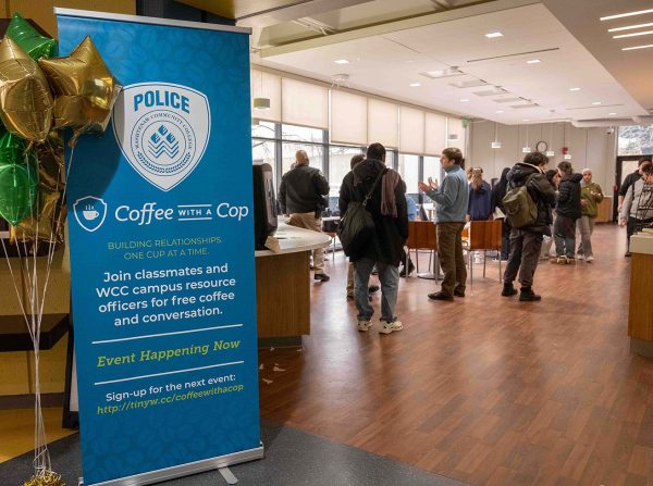 An upright banner is shown at the forefront of the image with a group of people standing in the background.