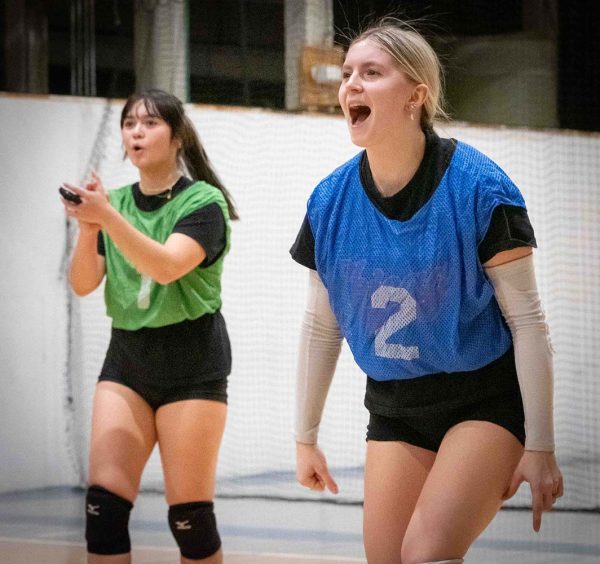 Ruth Kanuch and Mackenzie Roth clap ang get excited about a scored point.