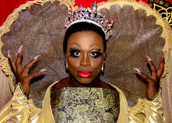 Bob the Drag Queen from RuPaul's Dragcon 2017 is shown wearing elaborate makeup, a tiara, and a golden royal costume.