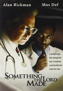 The poster for the film "Something the Lord Made" features two doctors focusing and thinking hard about something.