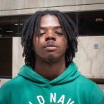 Headshot of Khalil Foy wearing a teal "Old Navy" hoodie.