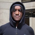 Headshot of Marrell Brown wearing a black cap and hoodie with the hood up.