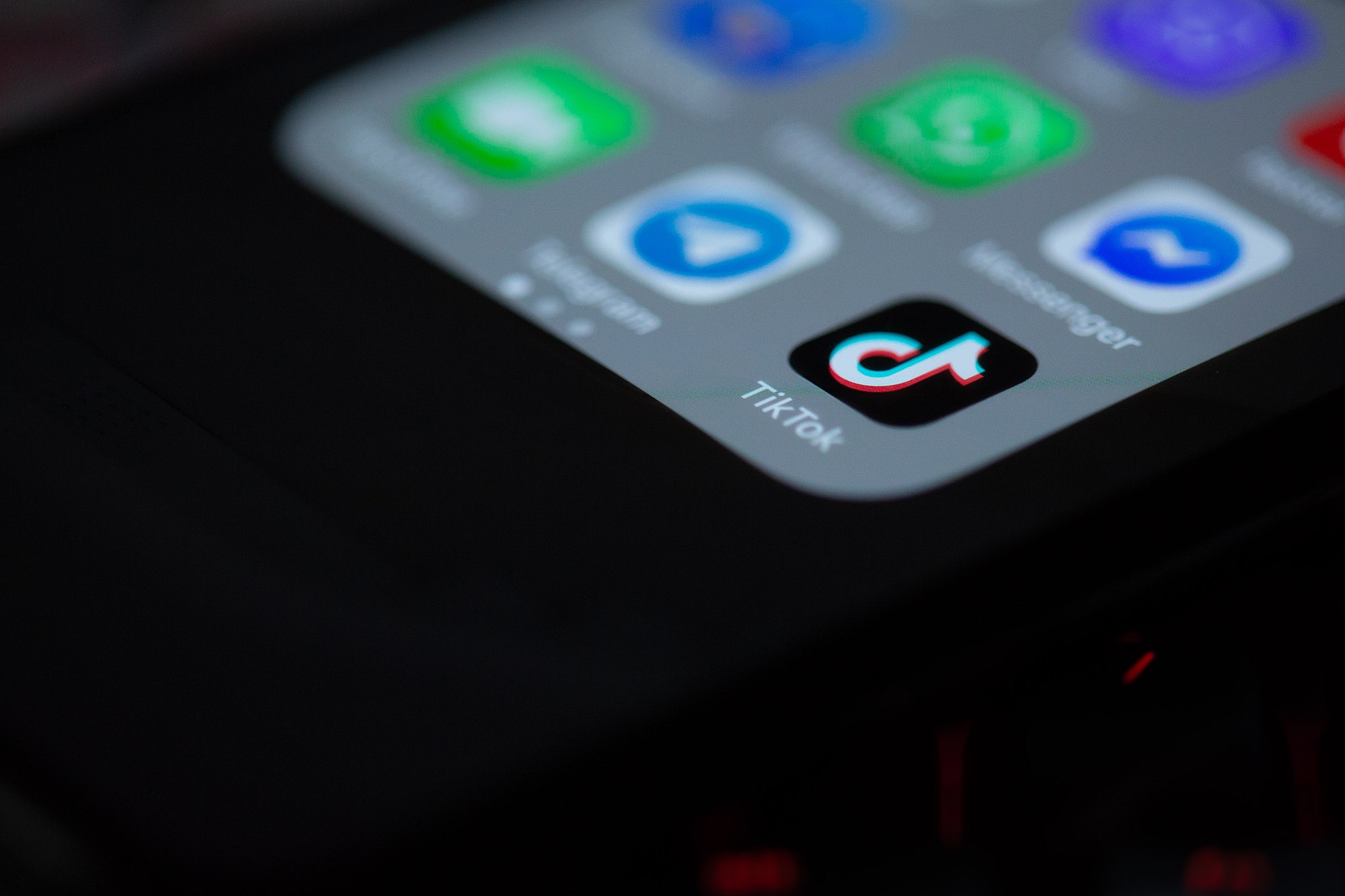 The corner of a phone screen is shown with the TikTok app in focus. 