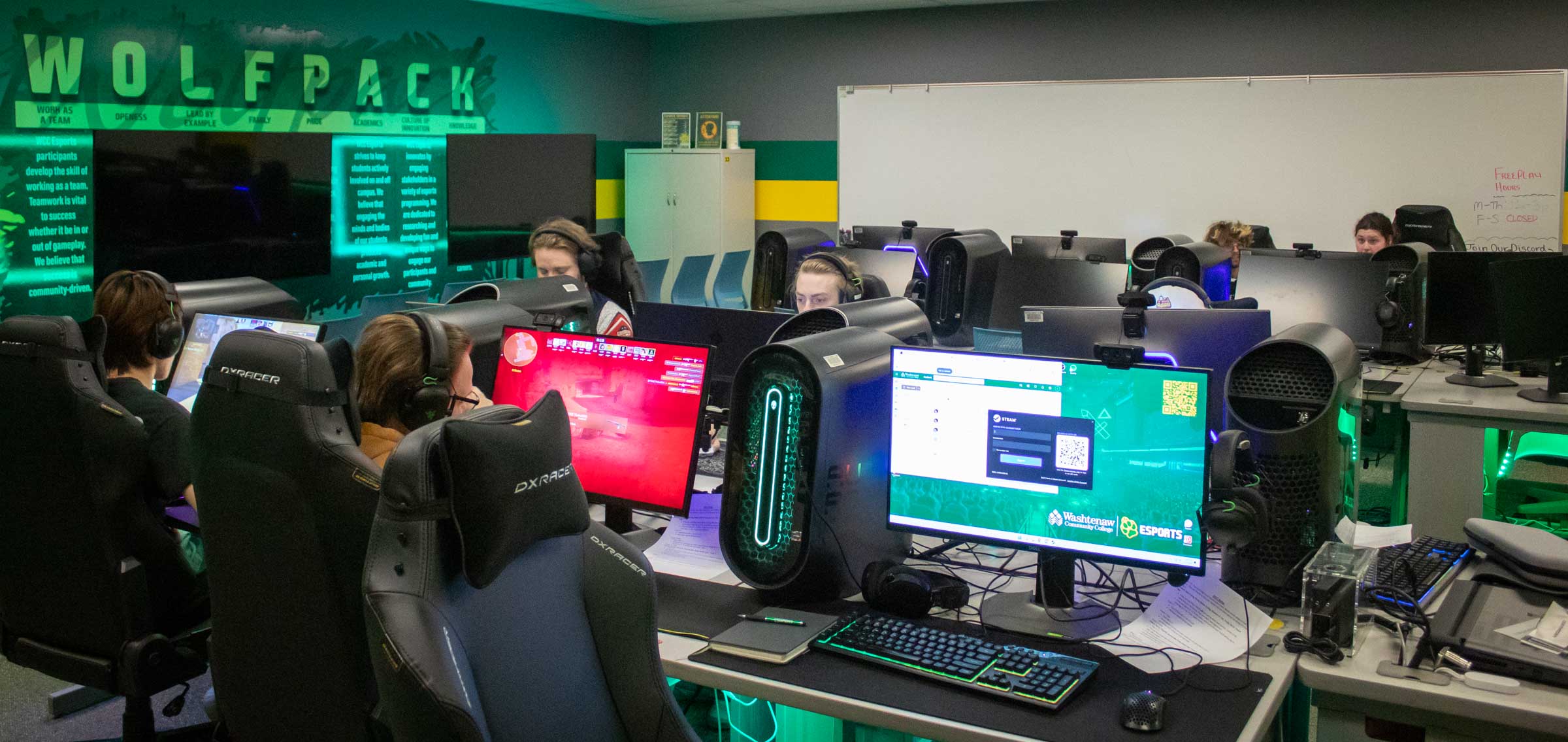 The WCC Esports gaming room is shown with six students sitting at their desks. The room is outfitted with PCs and monitors.