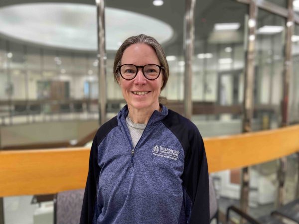 Becky Andrews stands on the third floor of the Student Center and smiles.